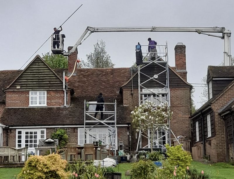 The Roof Moss Cleaners using cherry picker and scaffolding to clean roof safely and professionally in Westbury, Wiltshire